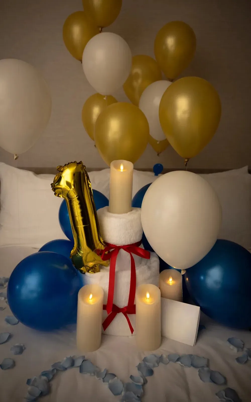 Towel swan arrangement with LED candles on a hotel bed